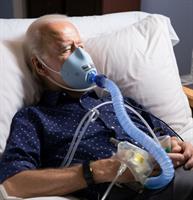 An image showing Joe Biden sleeping with a CPAP machine, which helps with his biden snoring and sleep apnea.