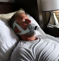 Brett Favre wearing a CPAP mask while sleeping