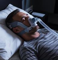 A person using a CPAP machine to treat sleep apnea